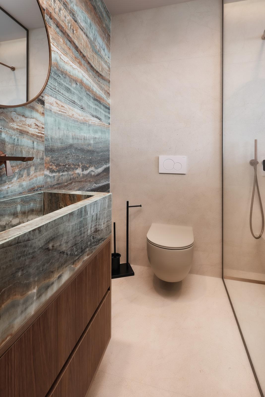 Bathroom with onyx feature wall, stone basin and walk-in shower