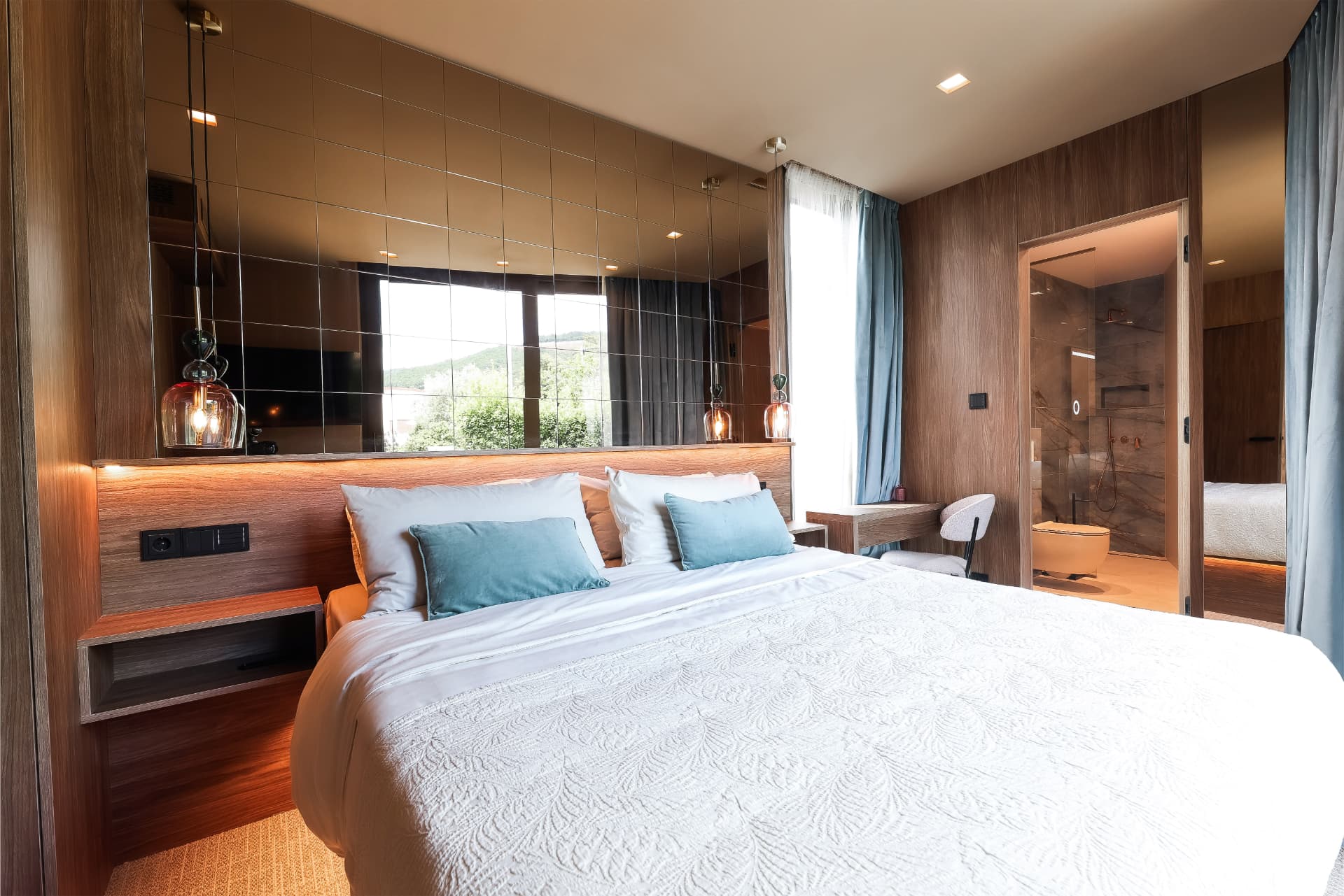 Master bedroom with walnut panelling and en-suite bathroom at IBoutique Luxury Villa Opatija