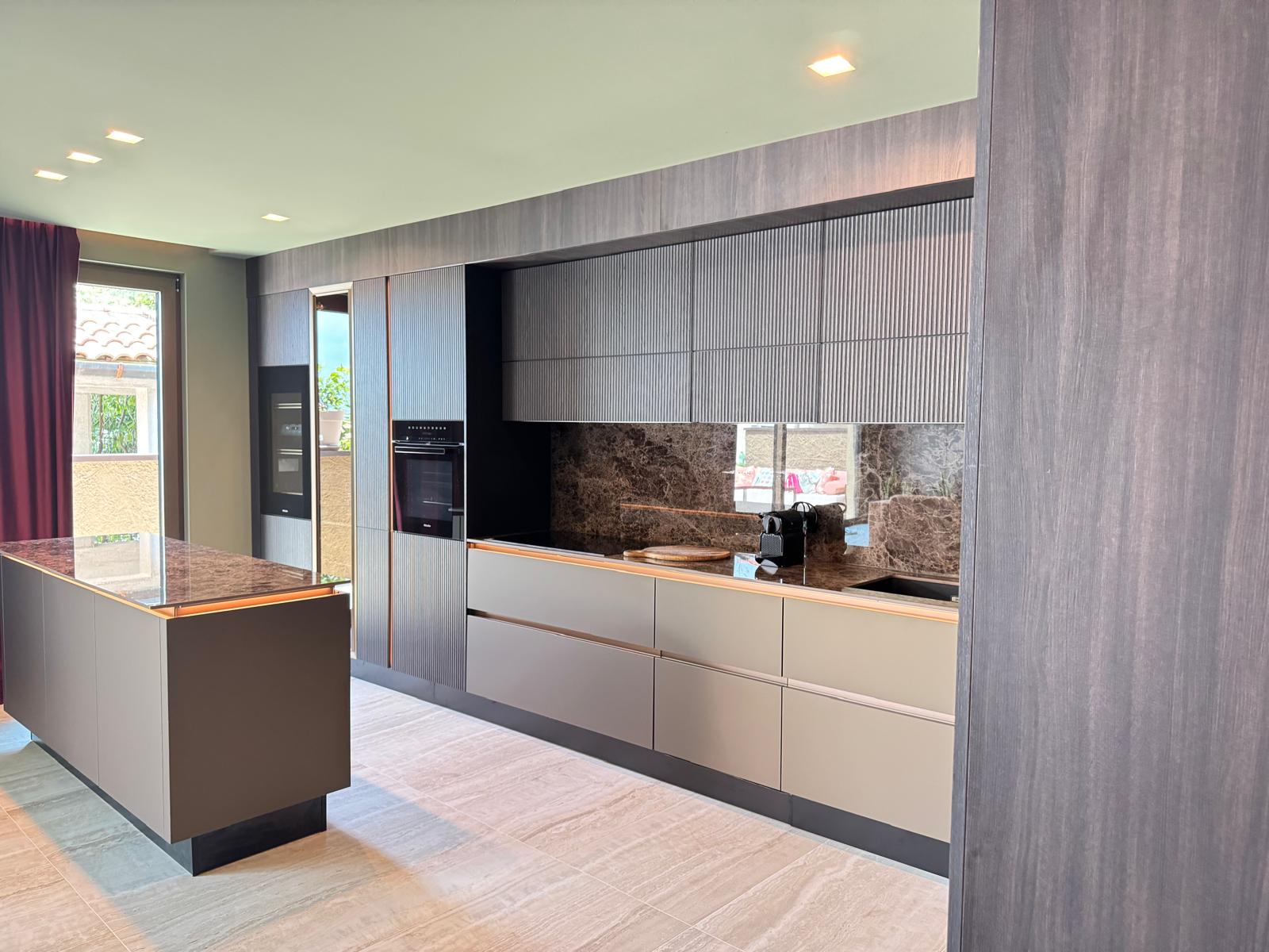 Fully equipped modern kitchen with Miele appliances and marble island