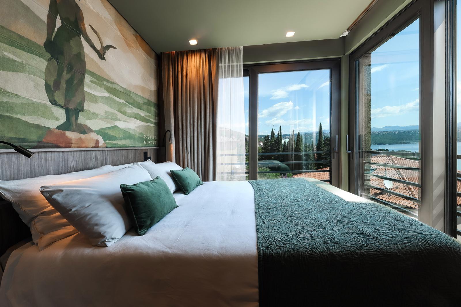Sea-view bedroom with balcony, painted mural headboard and Adriatic panorama