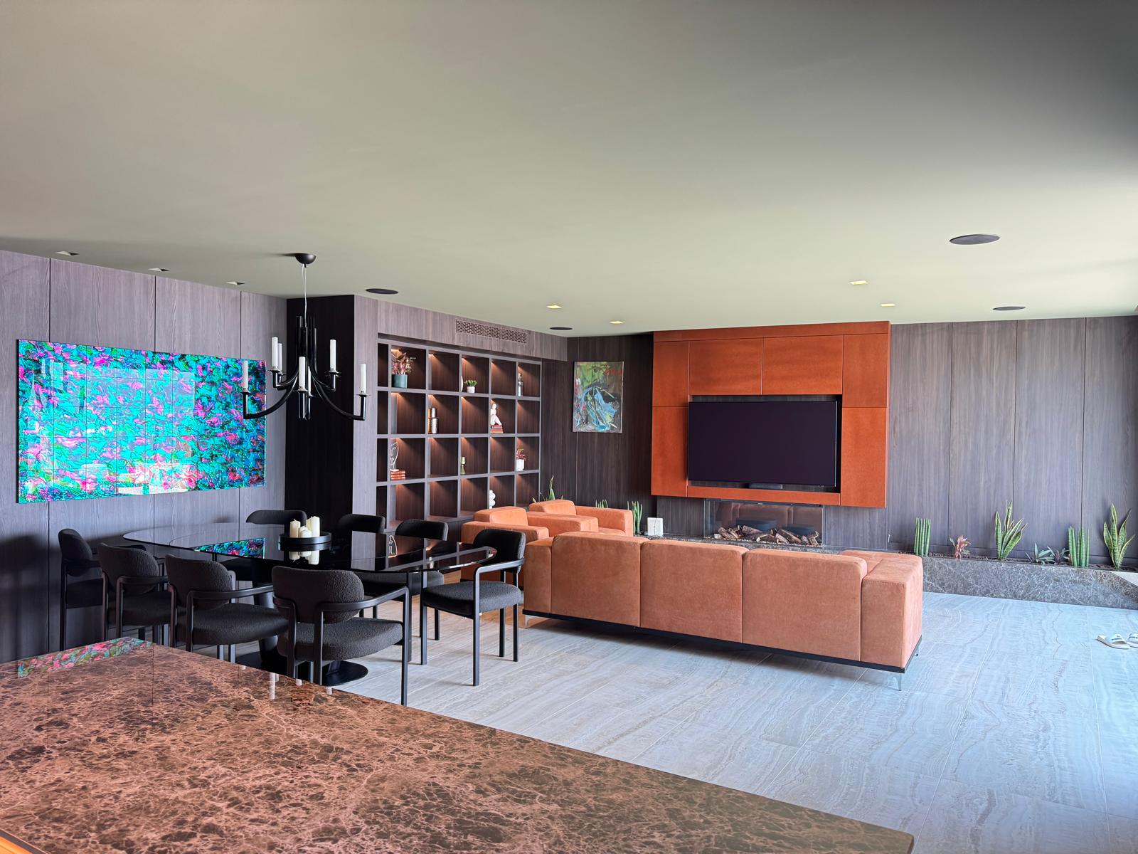 Open-plan living and dining area with fireplace, designer sofa and art in the Opatija luxury villa